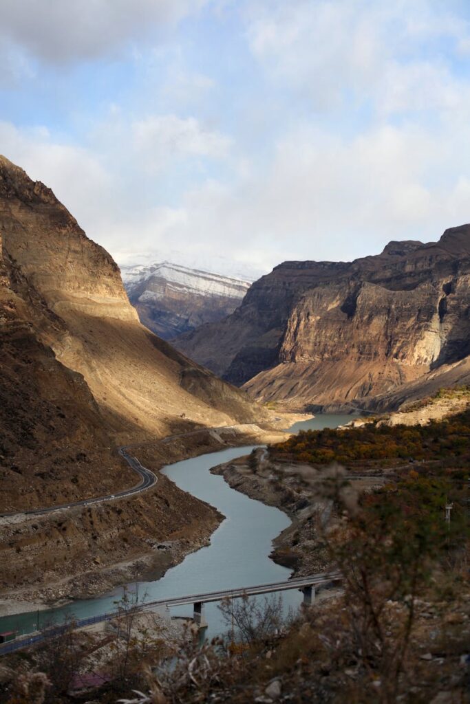 A winding river canyon illustrating how initial choices can lead to drastically different outcomes in crypto path dependency.