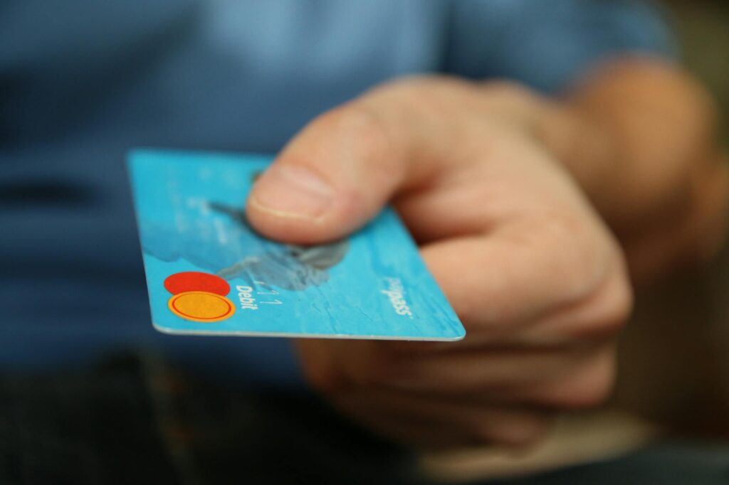 Close-up of a person's hand holding a smartphone displaying a cryptocurrency wallet interface with charts and balances.