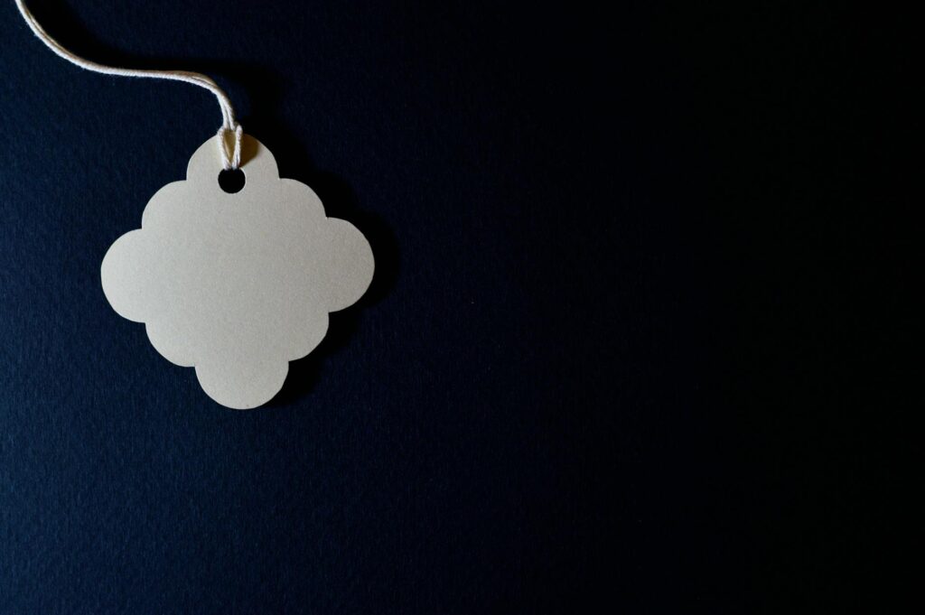 A close-up photograph of a physical Bitcoin coin resting on a sleek, dark surface, highlighting its texture.