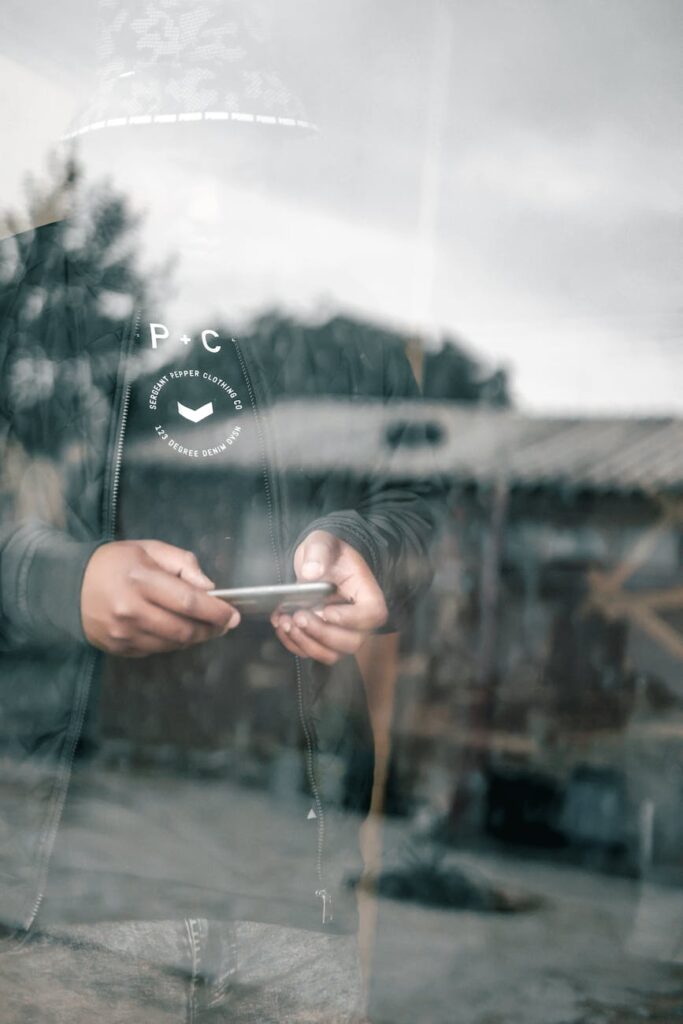A person holding a smartphone that displays a fluctuating cryptocurrency price graph against a blurred city backdrop at night.