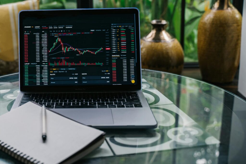 A focused trader analyzing multiple screens showing various cryptocurrency price charts and data.