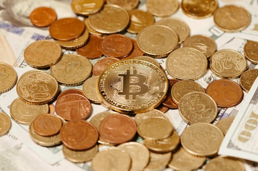Close-up of a smartphone screen showing the USDC stablecoin logo with a blurred background of a local market.