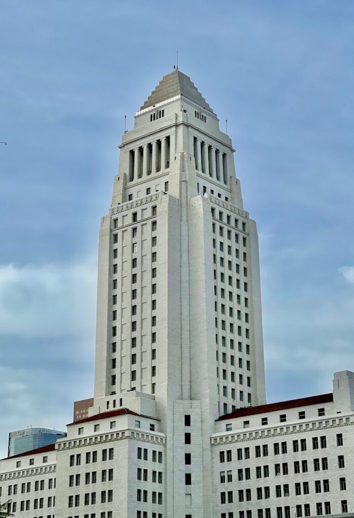 A classical government building with a glowing Bitcoin logo superimposed, symbolizing state adoption or regulation of crypto.