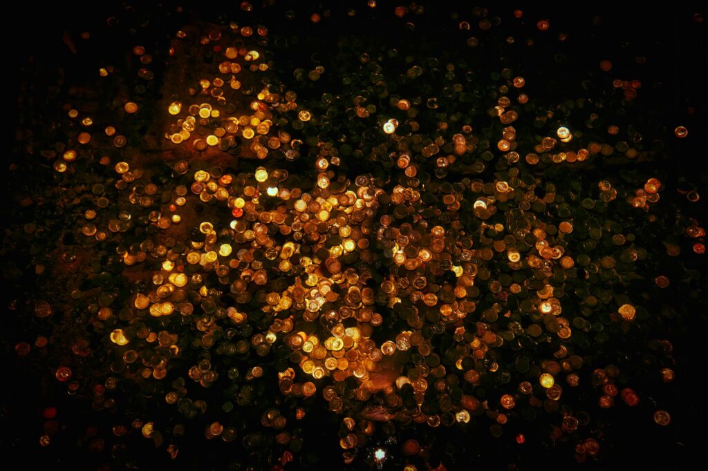 A detailed macro shot of a stack of physical gold bitcoin coins, symbolizing digital wealth and investment.