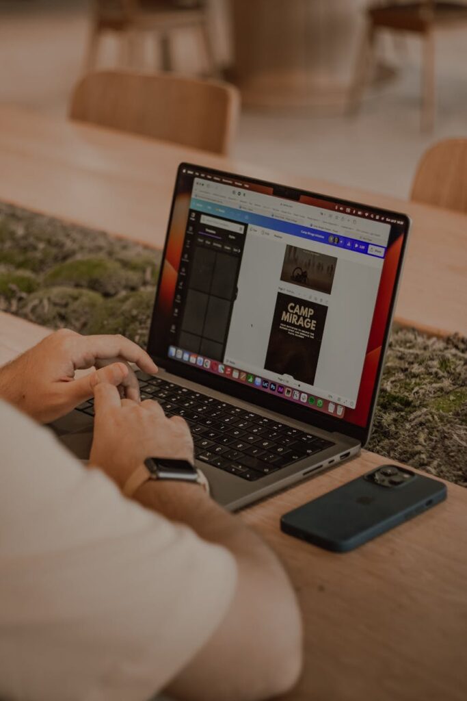 A sleek hardware wallet for cryptocurrency self-custody resting next to a laptop.