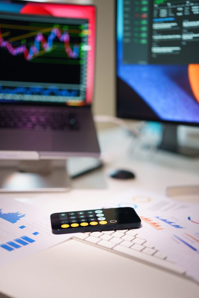 An investor thoughtfully analyzing a complex Bitcoin price chart displayed on a glowing computer monitor in a dimly lit room.