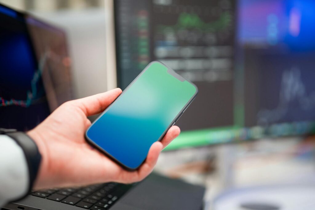 A focused investor analyzing complex cryptocurrency price charts on a dark computer monitor.
