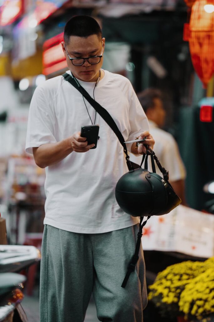 A trader anxiously checking a cryptocurrency price chart on their phone, illustrating market sentiment.
