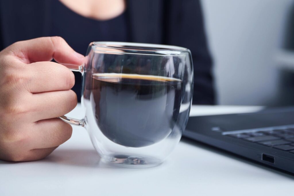 A detailed macro shot of a physical Bitcoin coin resting on the keys of a modern laptop, symbolizing digital currency.