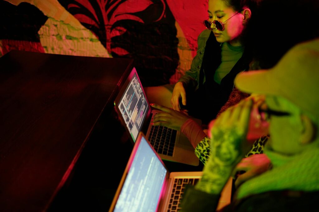 A programmer's screen filled with code, reflecting on their glasses in a dark environment, symbolizing a security audit.