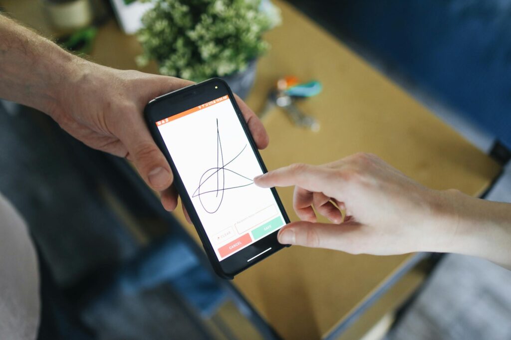 A person holding a physical hardware wallet used for securely storing cryptocurrency offline.