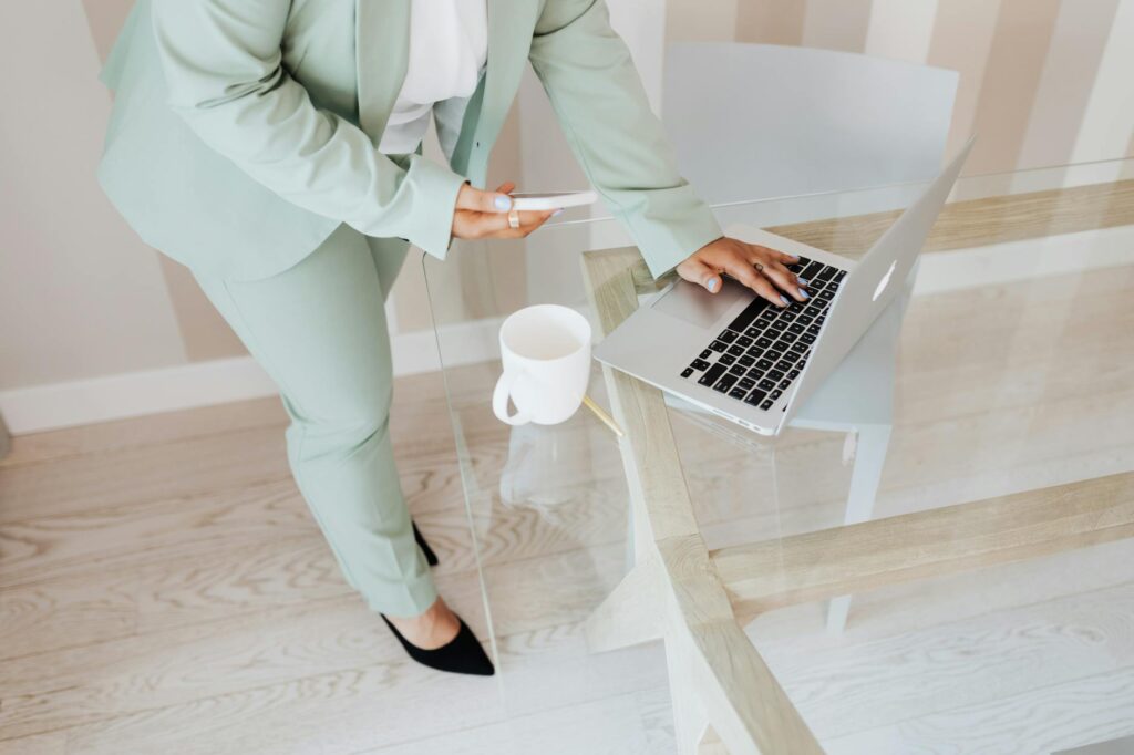 Close-up of a person's hand holding a smartphone, completing a secure digital transaction with cryptocurrency symbols overlaid.