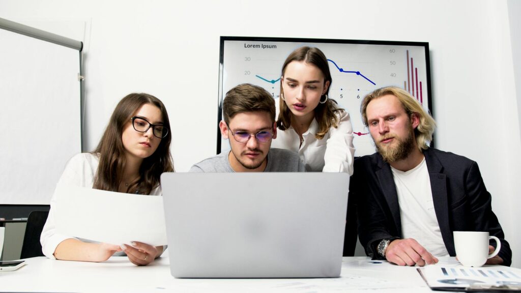 A focused individual analyzing a complex cryptocurrency price chart on their laptop screen at a desk.
