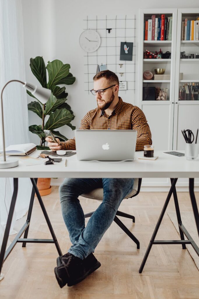 A content creator analyzing cryptocurrency price charts on a laptop screen, deep in thought about their digital assets.