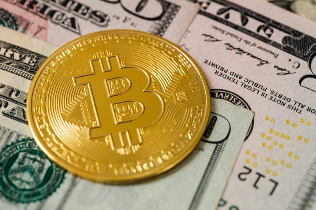 A symbolic image of physical gold bars placed beside a golden Bitcoin coin, illustrating the 'digital gold' debate.