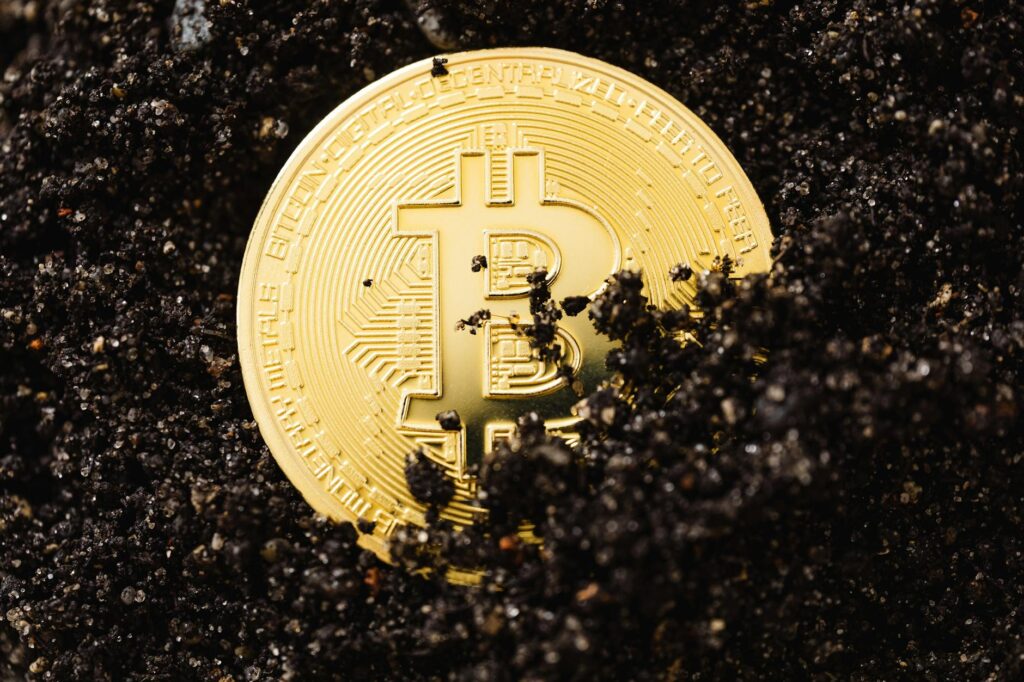 A detailed macro shot of a physical Bitcoin sitting on a modern computer keyboard.