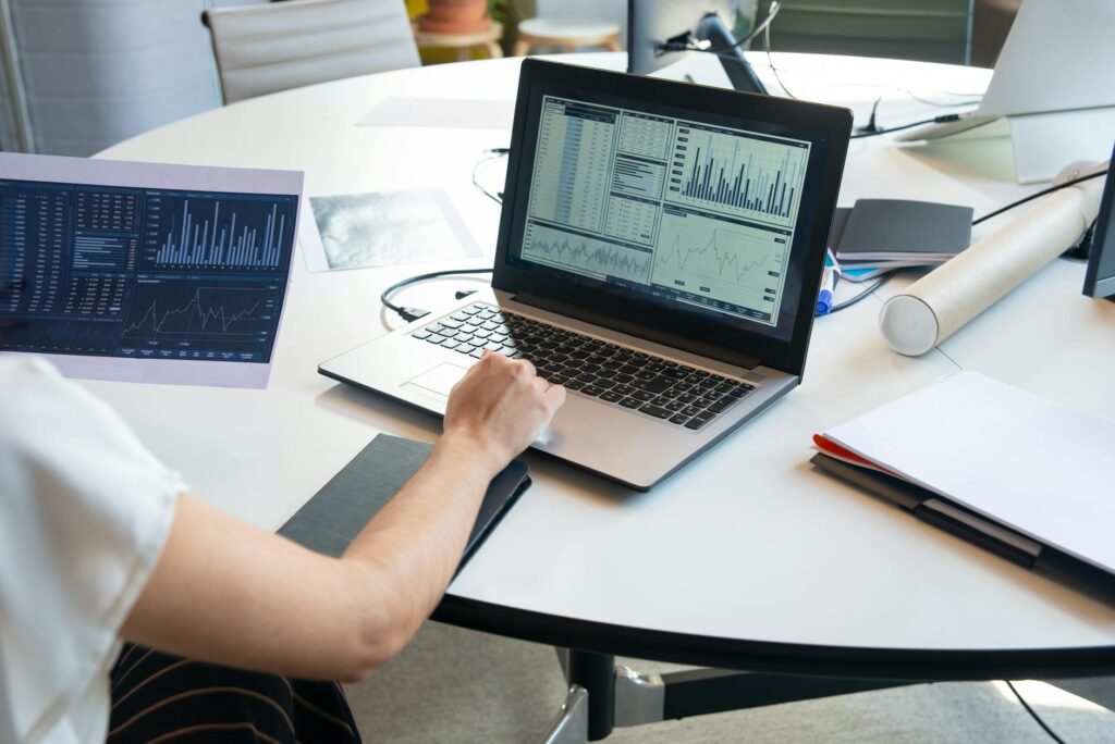A trader analyzing complex financial charts and data on a futuristic computer screen.