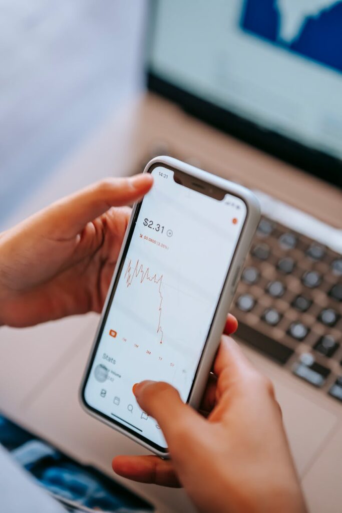 A close-up shot of a physical cryptocurrency coin glowing with a blue light, resting on a complex computer circuit board.