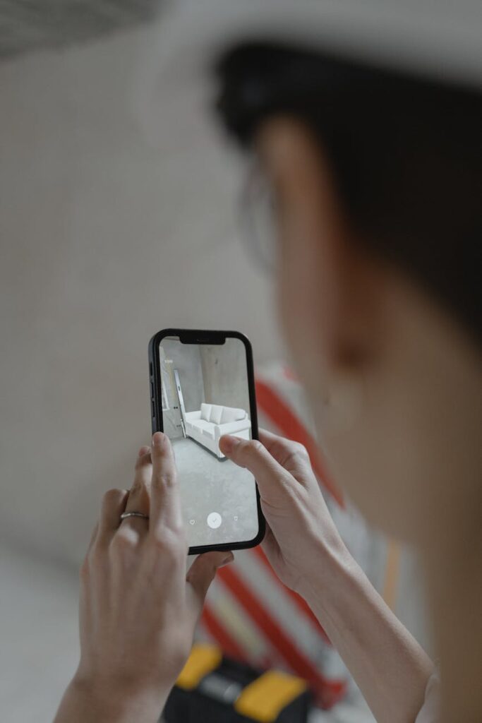 A person's hands holding a smartphone displaying a colorful cryptocurrency price chart with an upward trend.