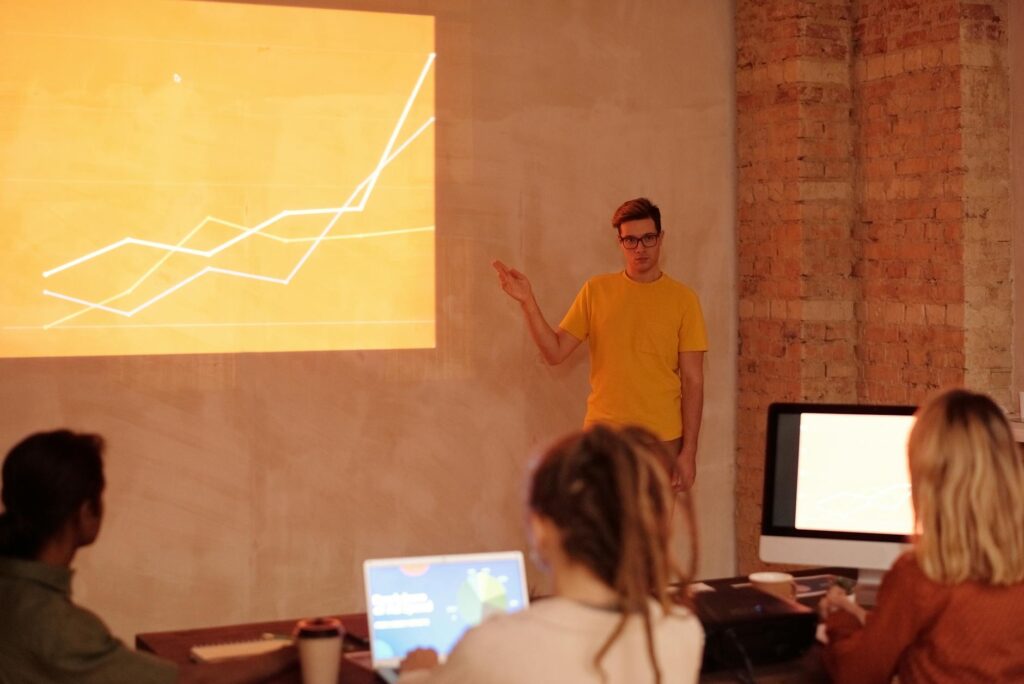 An analyst studying multiple screens filled with complex graphs and charts related to predictive crypto analytics.