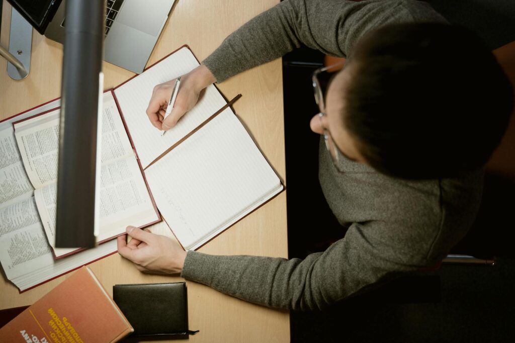 A person's hands on a laptop keyboard, with a web interface showing security permissions and settings.