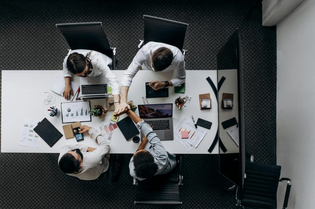 A group of diverse individuals discussing a project, illustrating decentralized collaboration.