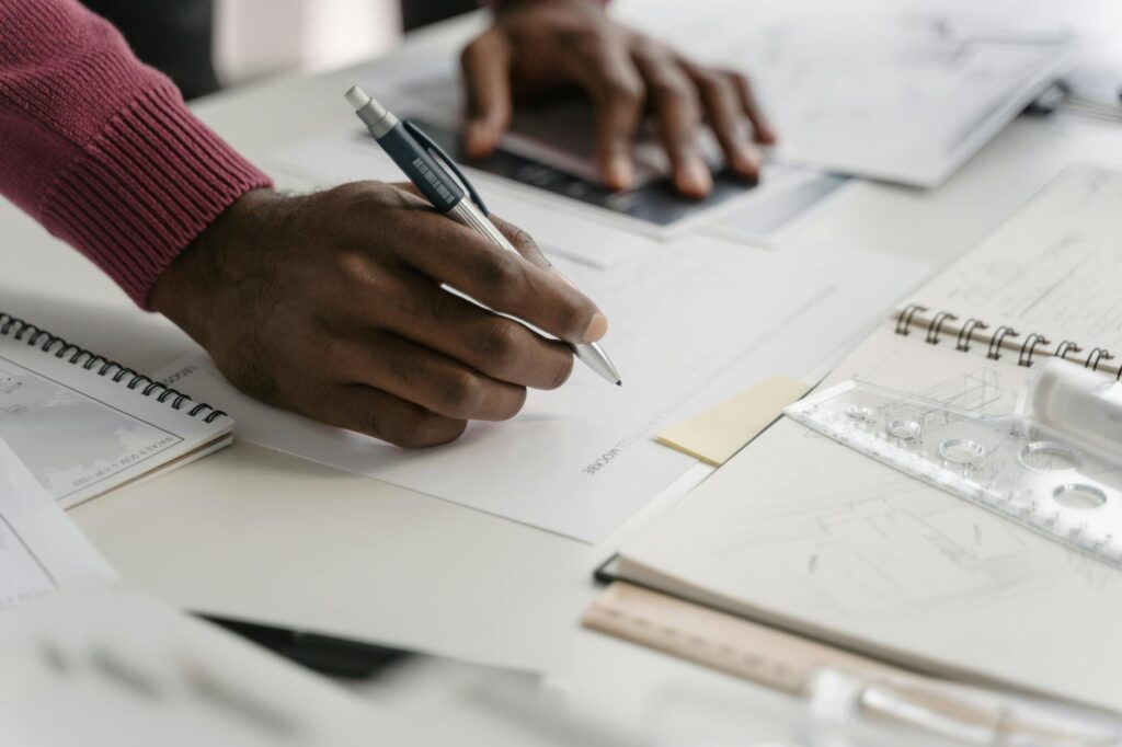 A close-up of a person carefully writing down a crypto seed phrase on a piece of paper for secure offline storage.