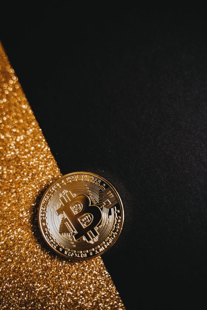 A close-up of a physical Bitcoin coin glowing with light on a complex computer motherboard.