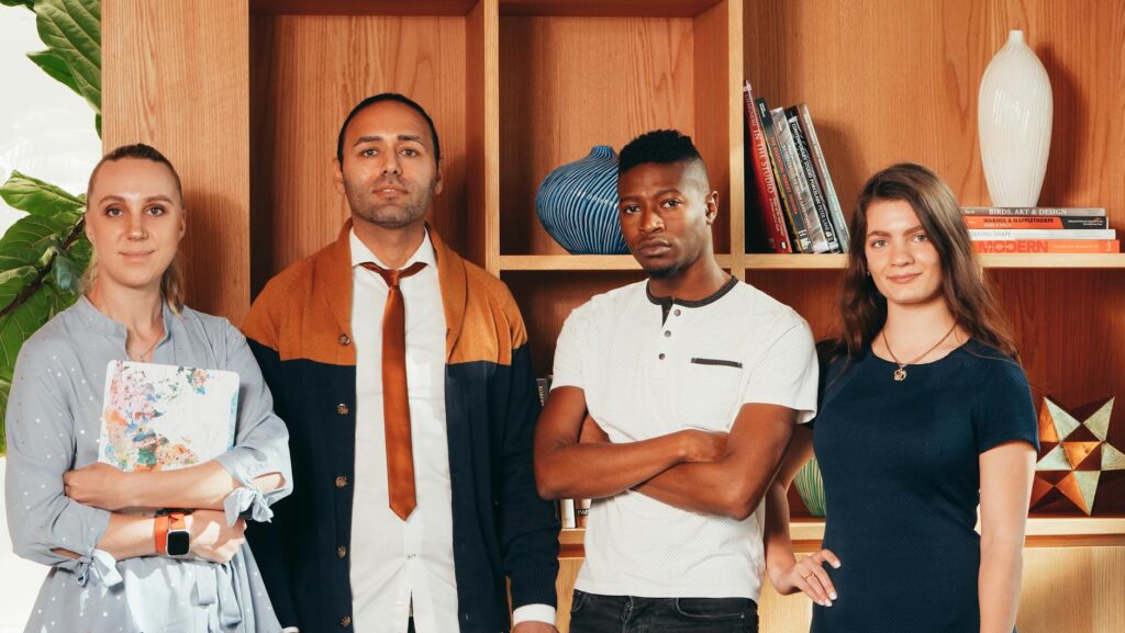 A multi-ethnic group of Gen Z students looking at a complex blockchain interface on a laptop in a modern co-working space.