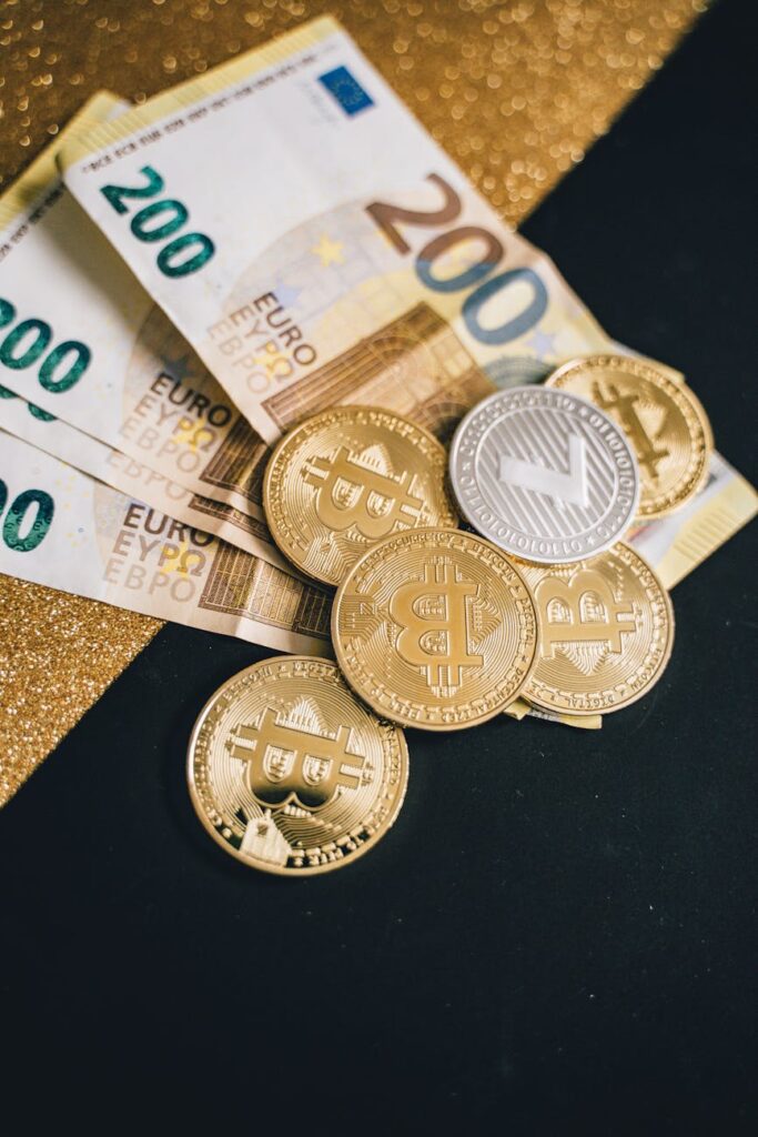 A scattered pile of various physical crypto coins including Bitcoin, Litecoin, and Ripple, representing a diverse portfolio.