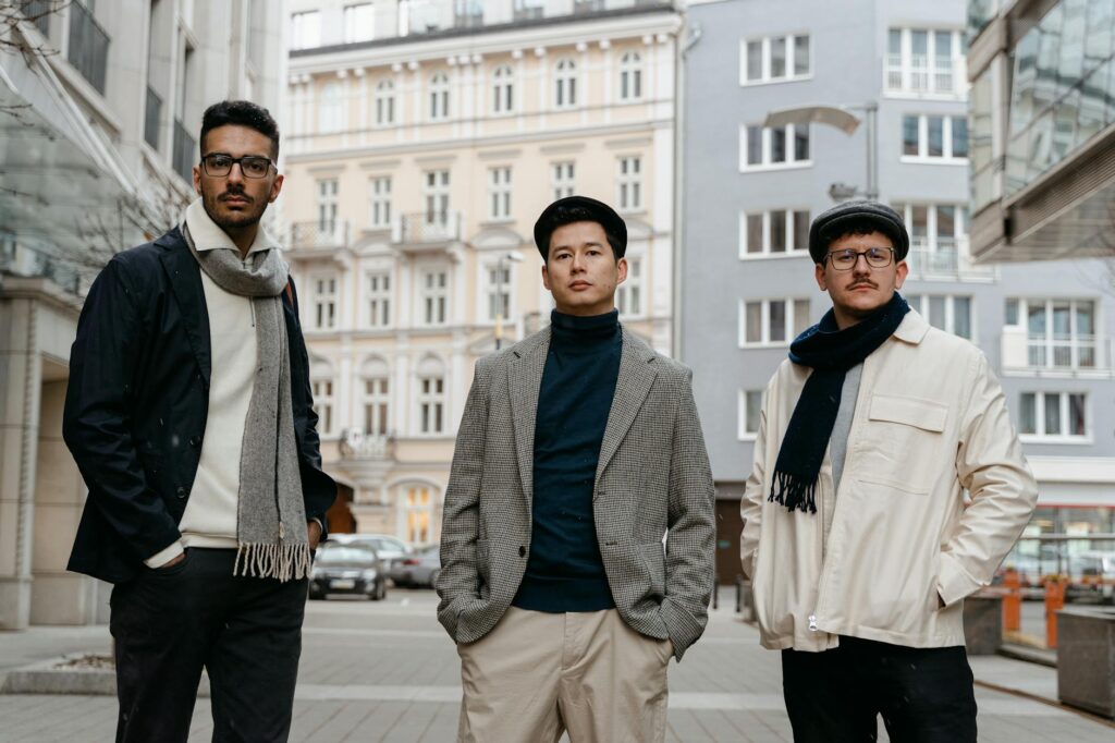 A diverse team of people working together around a table with laptops, illustrating the importance of community collaboration in DAOs.