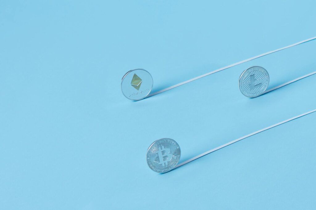 A detailed macro shot showing the textures and logos of physical Bitcoin and Ethereum coins.