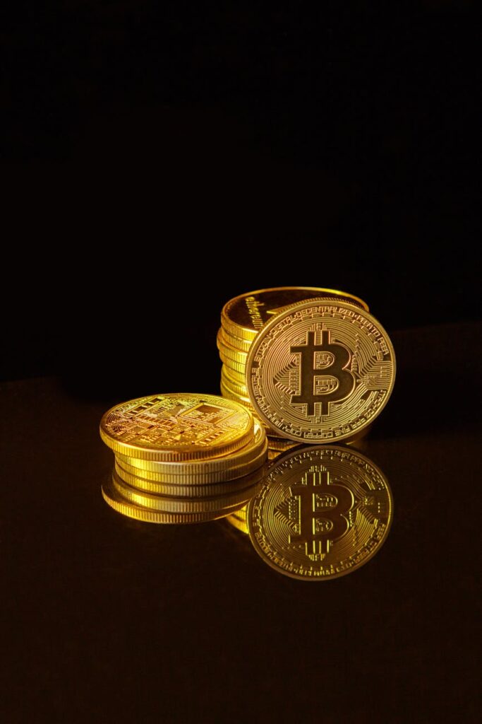 A close-up shot of a stack of physical gold bitcoin coins, symbolizing the value and investment aspect of cryptocurrency.