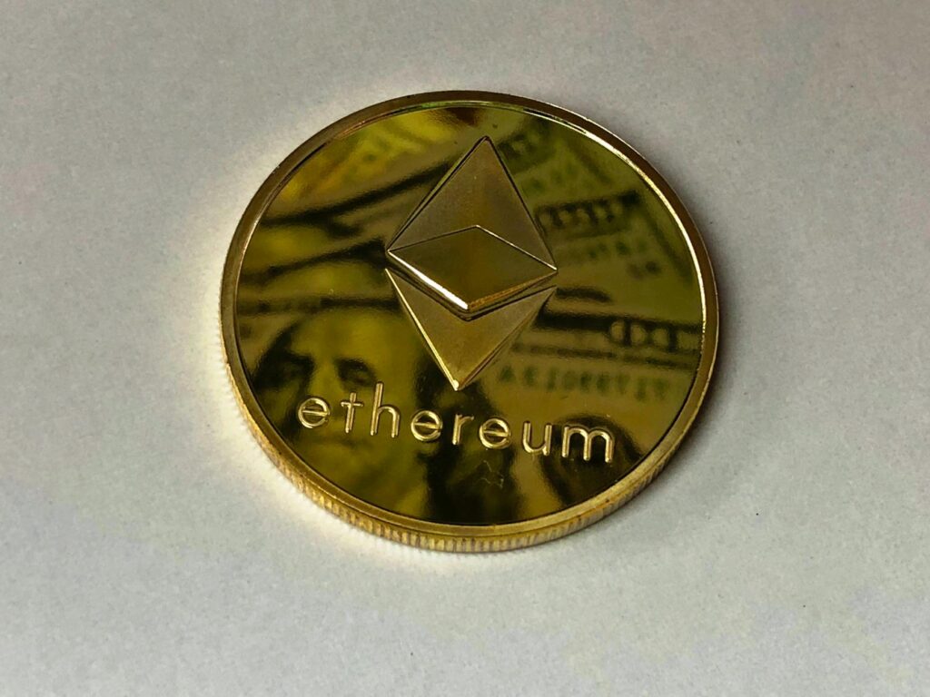 Close-up of a physical cryptocurrency coin, glowing with a blue light, resting on a complex computer circuit board.