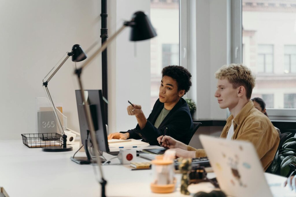 A diverse team of software engineers working together around a table, planning a secure project.