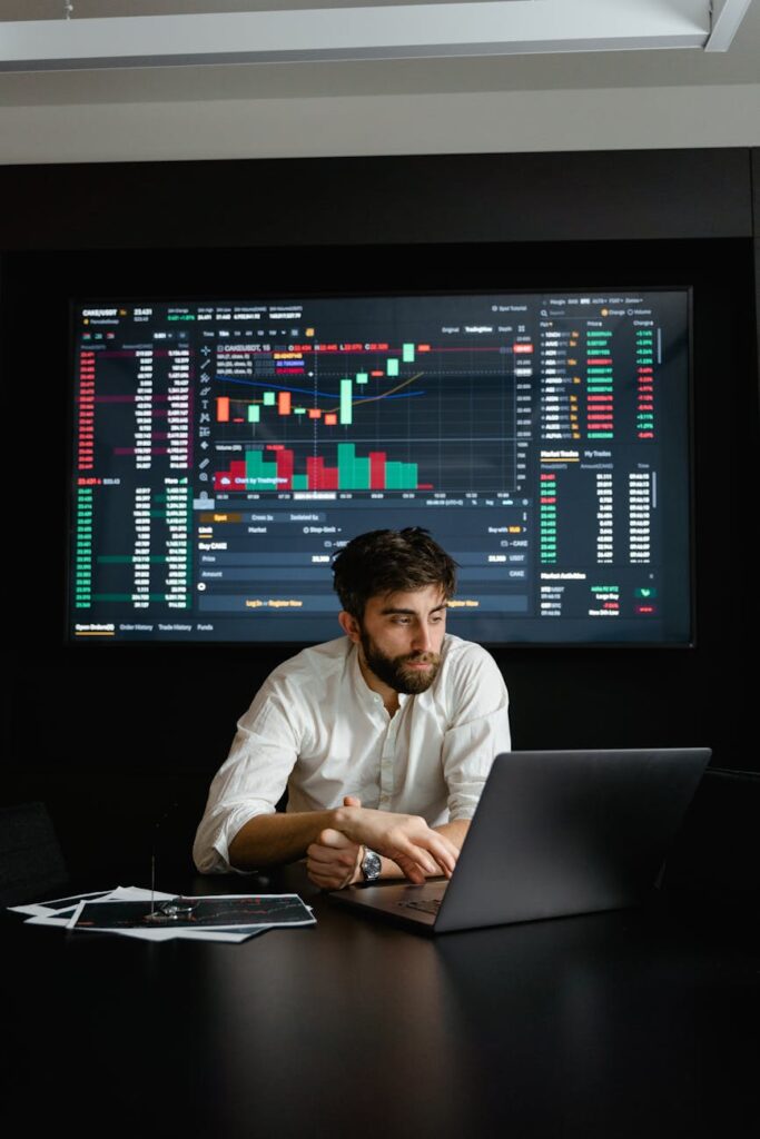 A liquidity provider carefully analyzing impermanent loss charts and market data on their computer.