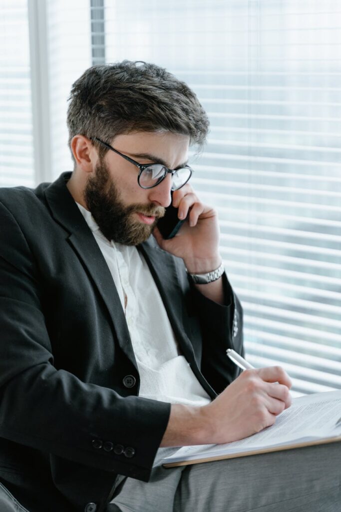 A concerned person holding a smartphone displaying a volatile cryptocurrency price graph with red and green lines.