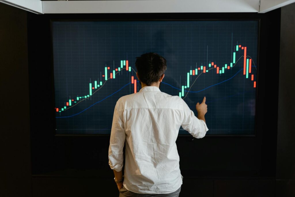 A focused investor or trader studying a complex cryptocurrency price chart with technical indicators on their monitor.