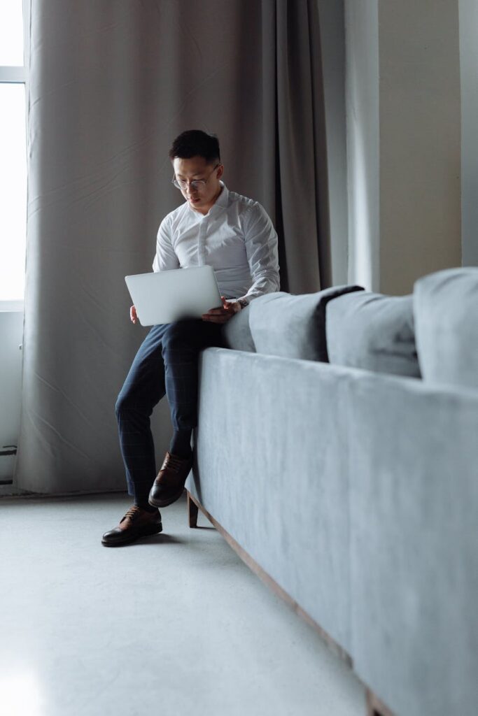 A person focused on their laptop screen which displays a colorful cryptocurrency portfolio dashboard.