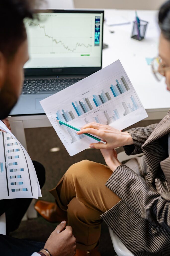 A focused individual analyzing cryptocurrency price charts on a modern laptop.