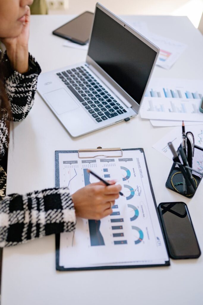 An investment analyst looking intently at multiple computer monitors displaying complex cryptocurrency price charts and market data.
