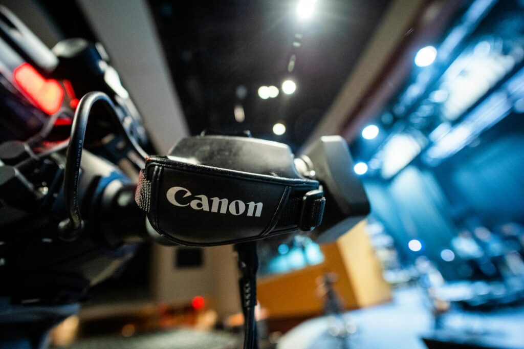 A team member pointing at complex data charts on a futuristic digital whiteboard.