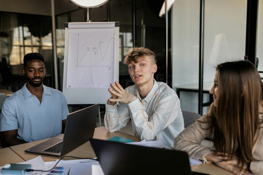 A diverse team of professionals analyzing cryptocurrency market charts on a large screen.