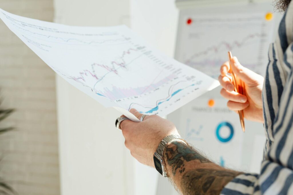 A red downward-trending financial graph superimposed over a backdrop of stock market data, symbolizing risk.