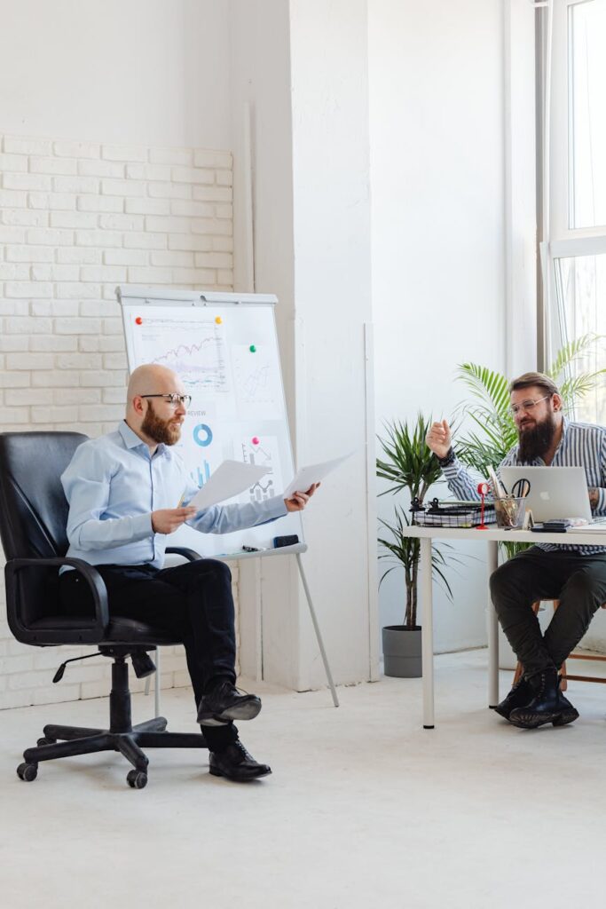 An overhead shot of a person looking concerned at a volatile cryptocurrency price chart on their tablet.