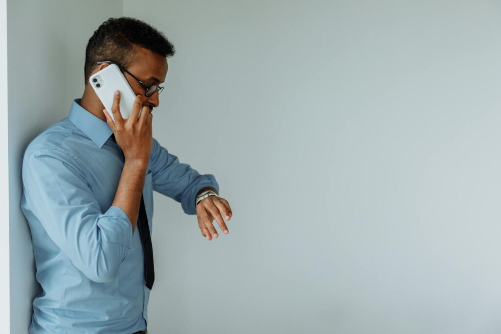 A concerned individual holding a smartphone, anxiously watching the fluctuating prices on a cryptocurrency exchange app.