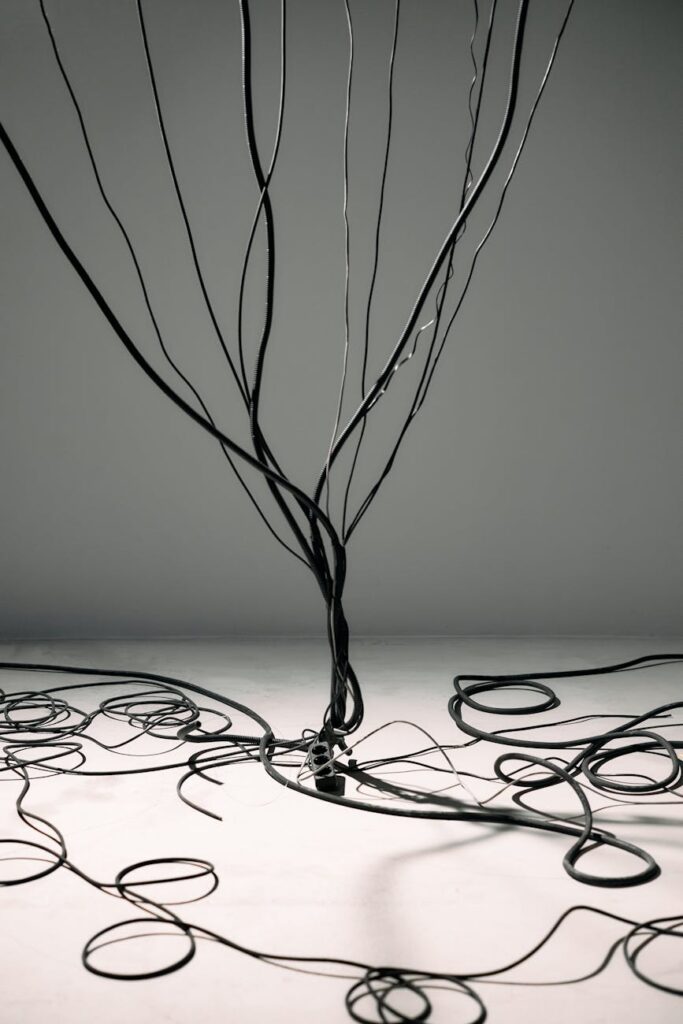 An intricate and glowing network of interconnected lines and dots against a dark background, representing a decentralized network.