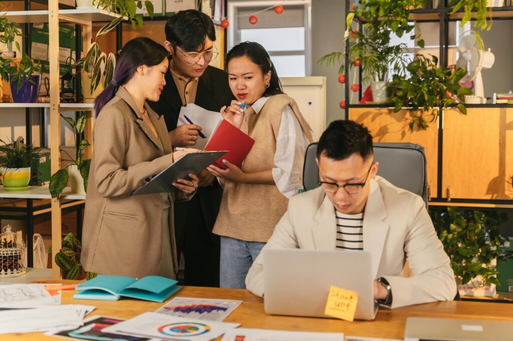 A group of young, diverse investors analyzing complex cryptocurrency data on a large monitor.