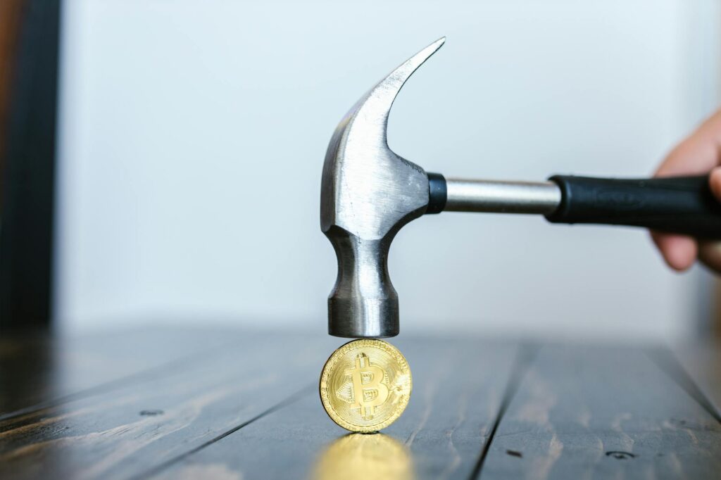 Detailed macro shot of a gold physical Bitcoin, showcasing its texture and the circuit design.