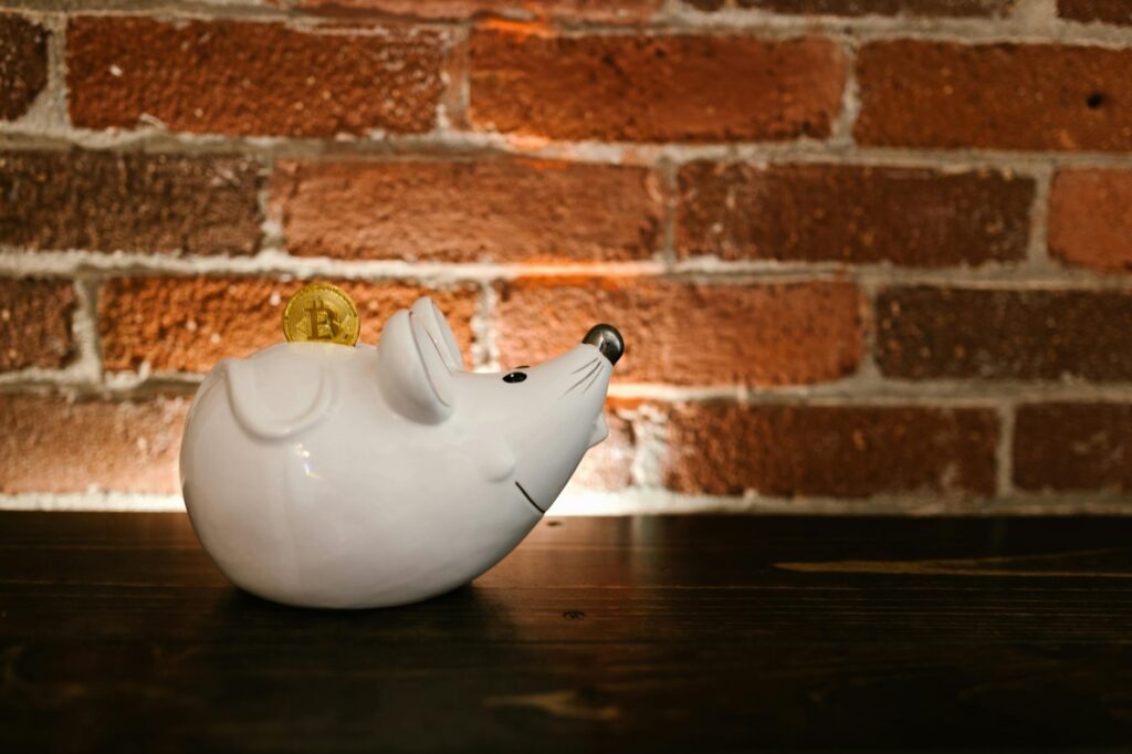 A close-up shot of a physical Ethereum coin glowing with blue light on a dark computer circuit board.